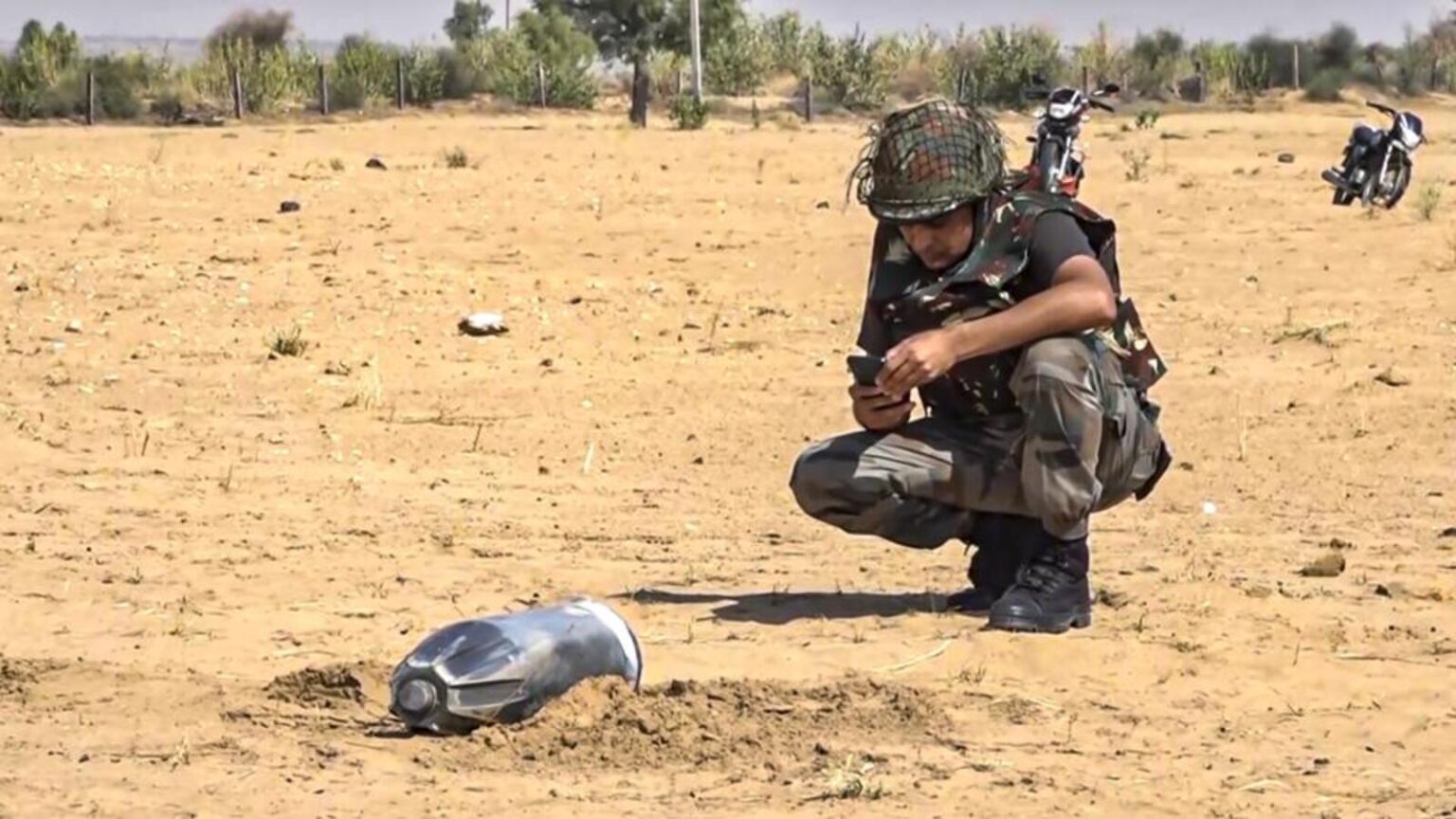 A security person inspecting the debris of a proje 1746861245119